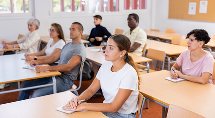 Sticker - Attentive university students in advanced training courses in the auditorium