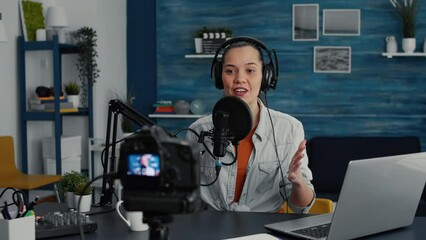 Canvas Print - Cheerful popular internet podcast show host ending live stream while sending air kisses to public. Social media popular infulencer saying goodbye to audience while sitting at home studio desk.