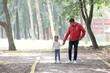 © Arlette - Latino divorced single dad and daughter walk in the park and spend quality time with physical activity, talk without using technology