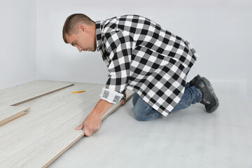 Poster - Professional worker installing new laminate flooring indoors