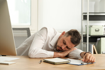 Canvas Print - Tired man sleeping at workplace in office