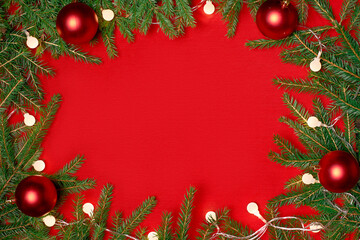 Wall Mural - frame of a Christmas wreath on a red background.