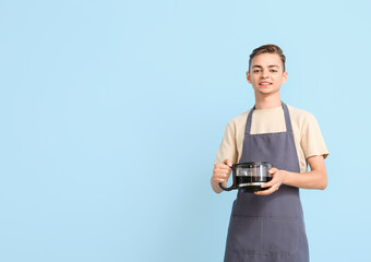 Wall Mural - Male barista with coffee maker on blue background