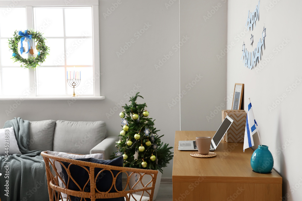 Modern workplace in room decorated for Hanukkah celebration