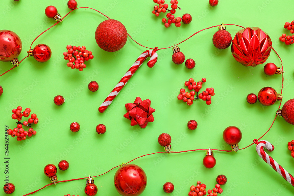 Christmas balls with rowan and candy canes on green background