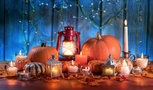 Pumpkins, Lantern And Candles On A Wooden Table. Thanksgiving Holiday And Autumn Harvest Festival Concept