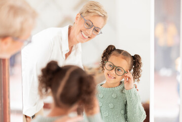 Canvas Print - Eye care, girl and optometrist help with vision, prescription glasses and eye test for childcare. Child, eyes and medical professional talking about clear sight for reading, improvement and eyewear.