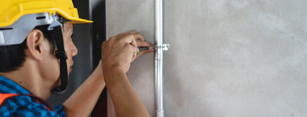 Wall Mural - construction worker and contractor. Electrician prepare to wire electric system on the ceiling in reconstruction room.