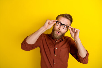 Wall Mural - Photo of positive man dressed stylish outfit wear eyewear interested look empty space isolated on yellow color background