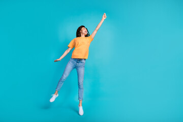 Wall Mural - Full length photo of positive carefree lady look sky hold empty space enjoy flight isolated on blue color background