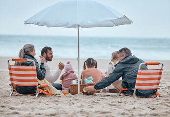 Sticker - Family, beach food and relax on holiday, vacation or trip outdoors on sandy seashore. Back view, bonding and grandparents and mom, dad and kids enjoying quality time together under beach umbrella.