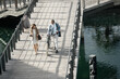 © David L/peopleimages.com - Walking, bicycle and team of business people talking, conversation or speaking while travel on river lake bridge. Journey, eco friendly transportation and cycling man and senior woman commute to work