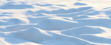Natural Winter Background With Snow Drifts And Falling Snow