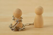 Wooden pawn with chains controlled by his partner - Concept of toxic relationship, love, domination and control