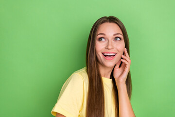 Poster - Portrait of gorgeous pretty cute girl straight hairstyle yellow t-shirt touch face look empty space isolated on green color background