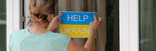 Woman Sticking Sign On Door Help Ukraine Closeup