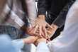 © itchaznong - Group of business people putting their hands working together on wooden background in office. group support teamwork agreement concept
