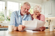 © Monkey Business - Worried Retired Senior Couple Looking At Bills At Home Concerned About Cost Of Living