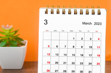 Close Up The March 2023 Monthly Desk Calendar For 2023 Year On Wooden Table.