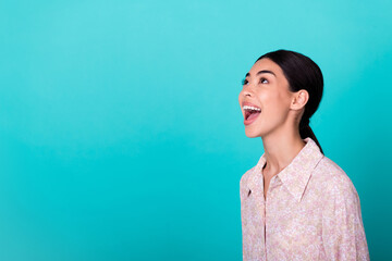 Wall Mural - Profile portrait of astonished positive person open mouth look interested empty space isolated on aquamarine color background