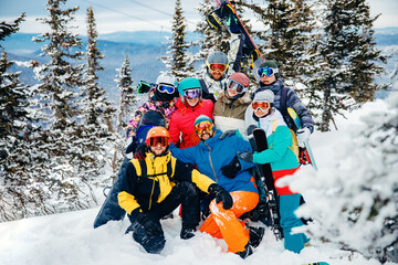 Team winter sports skiers and snowboarders with sun light. Concept travel ski resort with group of friends