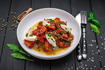 Canvas Print - Fried eggplant slices in spicy tomato sauce with cream cheese.