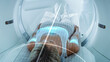 © Gorodenkoff - Female Patient Lying on CT or PET or MRI Scan Bed, Moving Inside the Machine While it Scans Her Brain and Body. Augmented Reality Concept with Visual Effects In Hospital Lab with High-Tech Equipment.