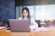 © EduLife Photos - Teenage Asian girl student studying online on a laptop writing notebook in a private studying room