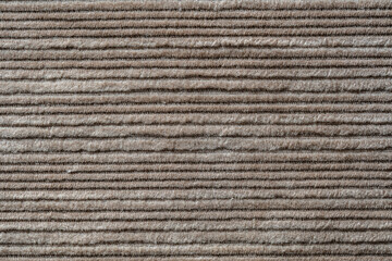 Wall Mural - Texture backdrop of beige colored corduroy fabric cloth. Corduroy retro fabric background or texture. Closeup view