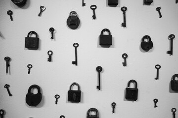 Wall Mural - A set of old worn keys and vintage locks on the grey concrete wall background.