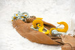 Yellow construction hooks and slings for unloading cargo and loading cargo lie on the snow. Outdoors. 