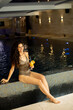 © BGStock72 - Young woman relaxing and drinking orange juice on the poolside