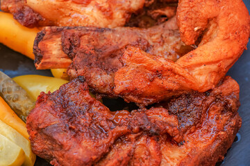 Wall Mural - Grilled juicy ribs with baked crust with vegetables close-up.