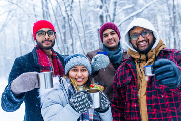 Wall Mural - Happy young indian friends get warming with hot tea