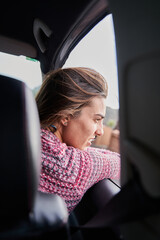 pretty girl looks out the car window