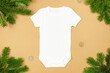 Christmas white baby girl or boy bodysuit mockup flat lay with xmas tree branches and snowflakes decoration on paper background. Design onesie template, print presentation mock up. Top view. 