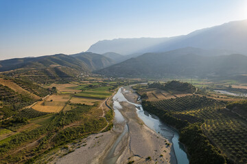 Wall Mural - Aerial view of river Osumi by village Mbrakull near Polican in Albania in Summer sunrise