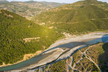 Wall Mural - Aerial view of river Osumi by village Mbrakull near Polican in Albania in Summer sunrise