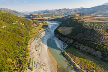 Wall Mural - Aerial view of river Osumi by village Mbrakull near Polican in Albania in Summer sunrise