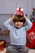 © Tamara Sales  - Boy opening up present for christmas