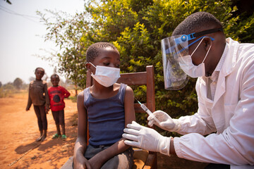 open air vaccination session in an african village during corona virus pandemic