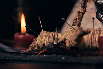 Wall Mural - Voodoo doll in ritual scene close up, magic table with candles, witchcraft and spirituality concept.