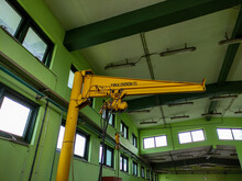 500 Kgs Capacity Of Yellow Crane Standing In The Manufacturing Area.