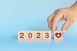 New year 2023 health goal and healthcare priority concept. Wooden blocks on blue background with icon.