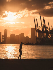 Wall Mural - silhouette of a person on the beach south point miami Florida sunset time 