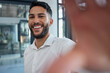 Selfie, happy and success with a business man taking a picture while standing alone in the office at work. Portrait, confidence and smile with a male employee posing for a photograph while working