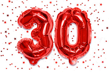 Wall Mural - The number of the balloon made of red foil, the number thirty on a white background with sequins. Birthday greeting card with inscription 30. Anniversary concept. Celebration event.