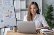 © David - Business woman using calculator for do math finance on desk in Home office, Asian female finance business tax, accounting, statistics and analytic research concept