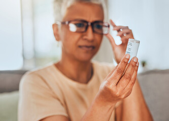 glasses, medicine and pills senior woman reading information for healthcare, insurance and wellness 