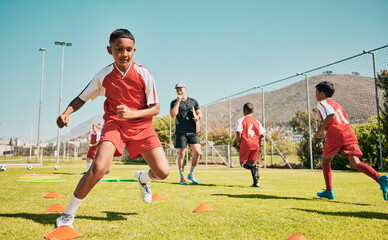 Canvas Print - Soccer, children and training or practice for sports competition or game on soccer field for fitness, exercise and energy. Football player, cone and sport with kids coach outdoor for team practice